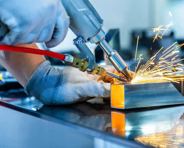 Person welding metal with sparks flying.