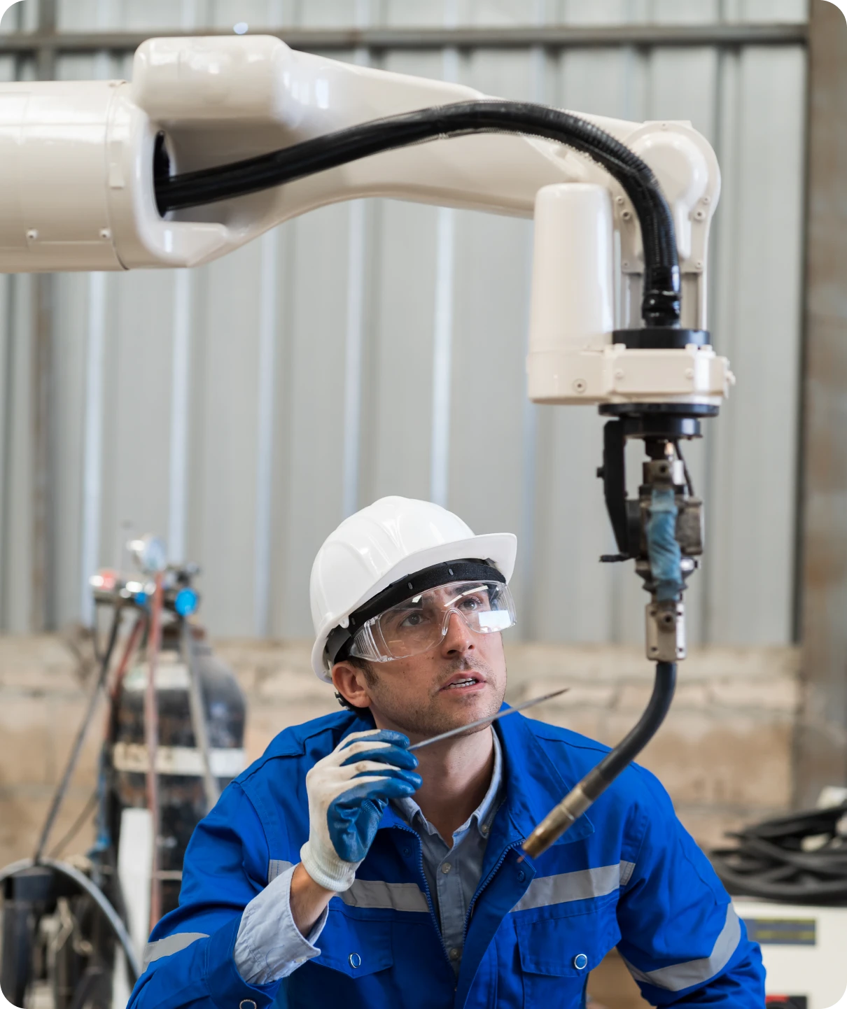 Worker examines robotic equipment