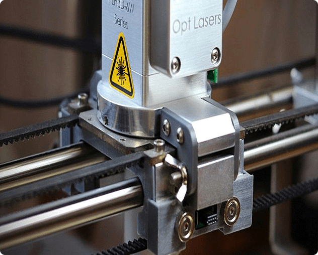 Laser machine close-up with warning sign