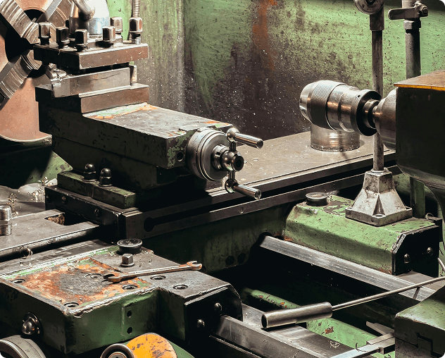 Industrial metal lathe in a workshop setting.