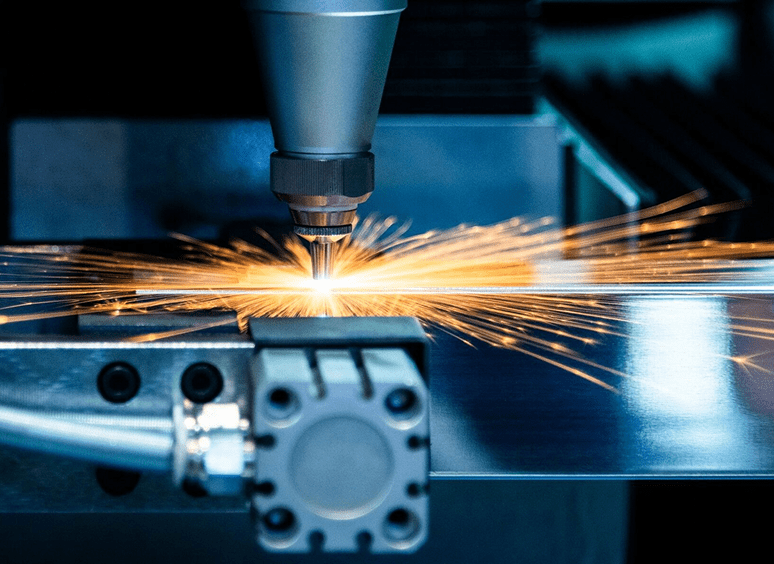 Laser cutting metal with bright sparks.