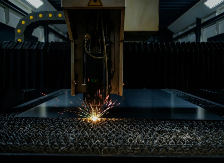 Laser cutting metal with sparks flying