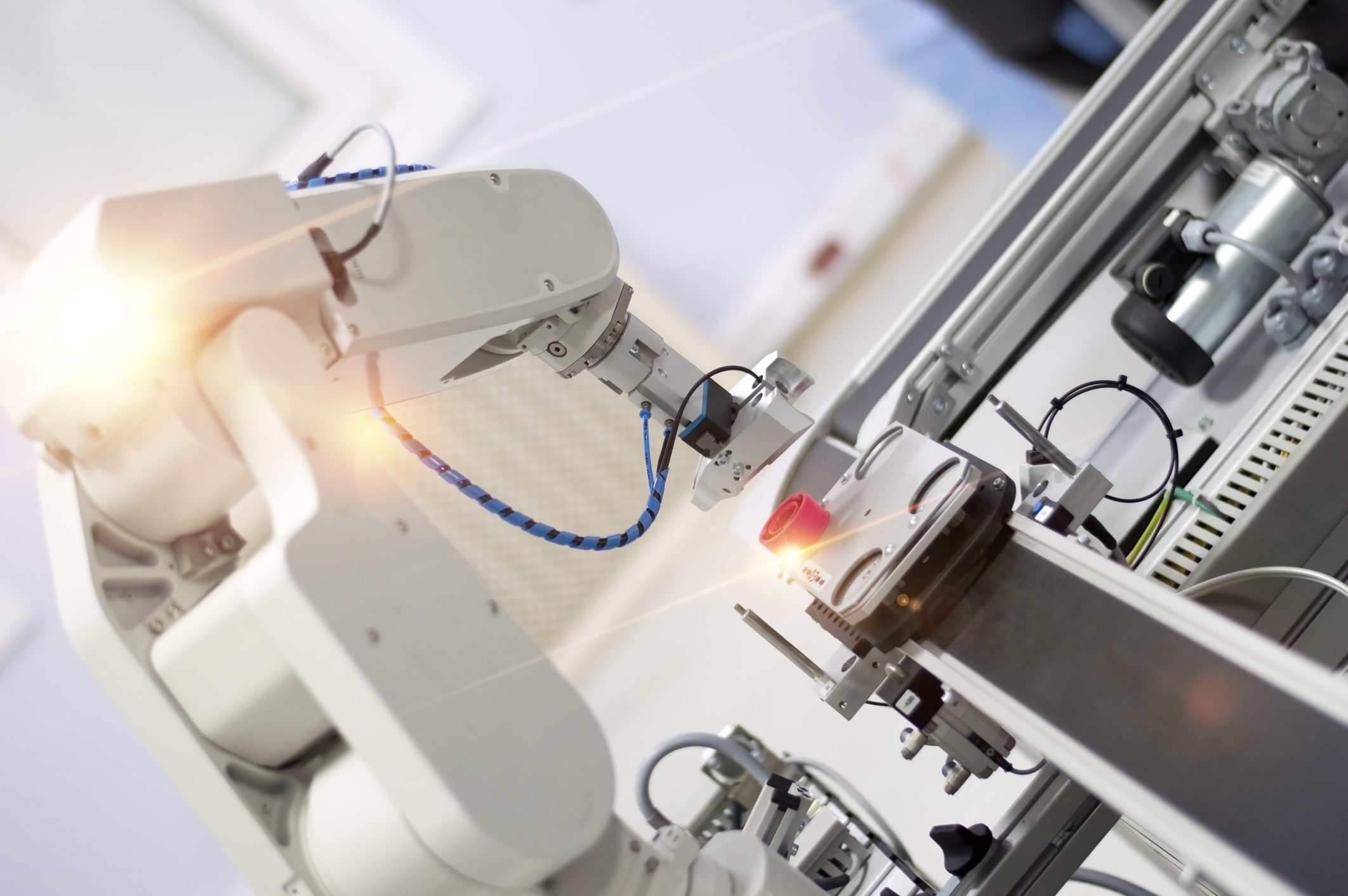 Robotic arm working in industrial setting.