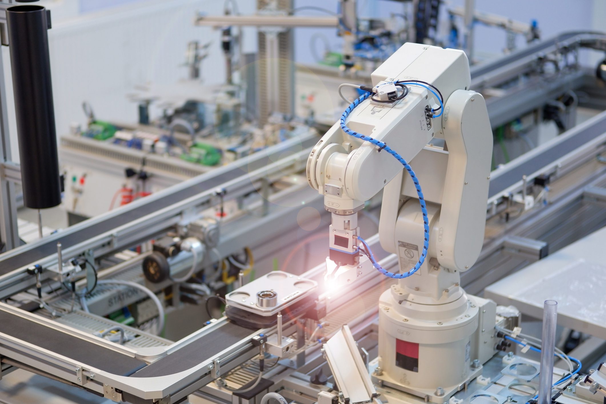 Robotic arm operating on an assembly line.
