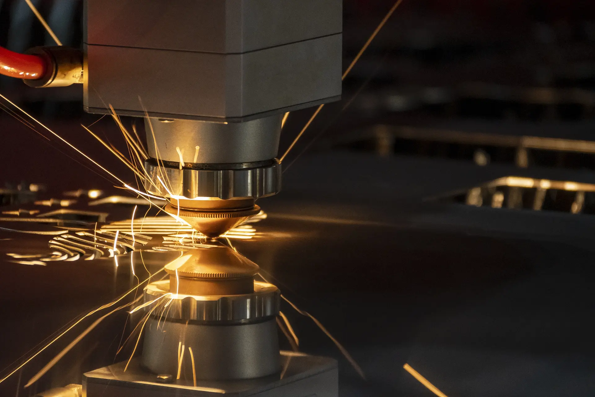 Laser cutting metal with sparks flying.
